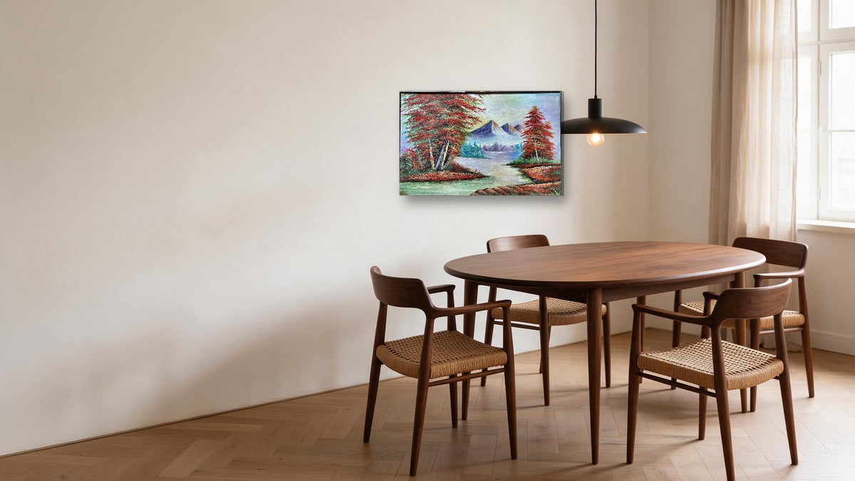 Hand-painted mountain river landscape canvas with red autumn trees and snow peaks, shown in a dining room