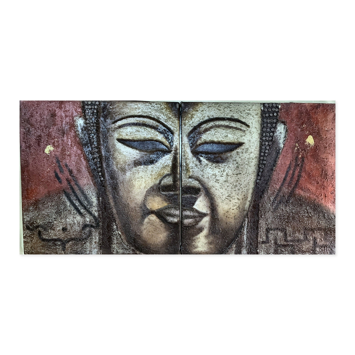 Hand-painted Buddha face diptych in textured relief across two panels on oxblood red