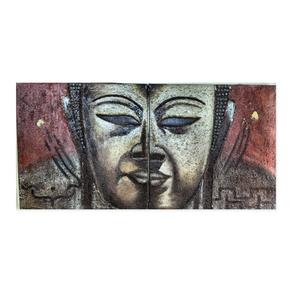 Hand-painted Buddha face diptych in textured relief across two panels on oxblood red