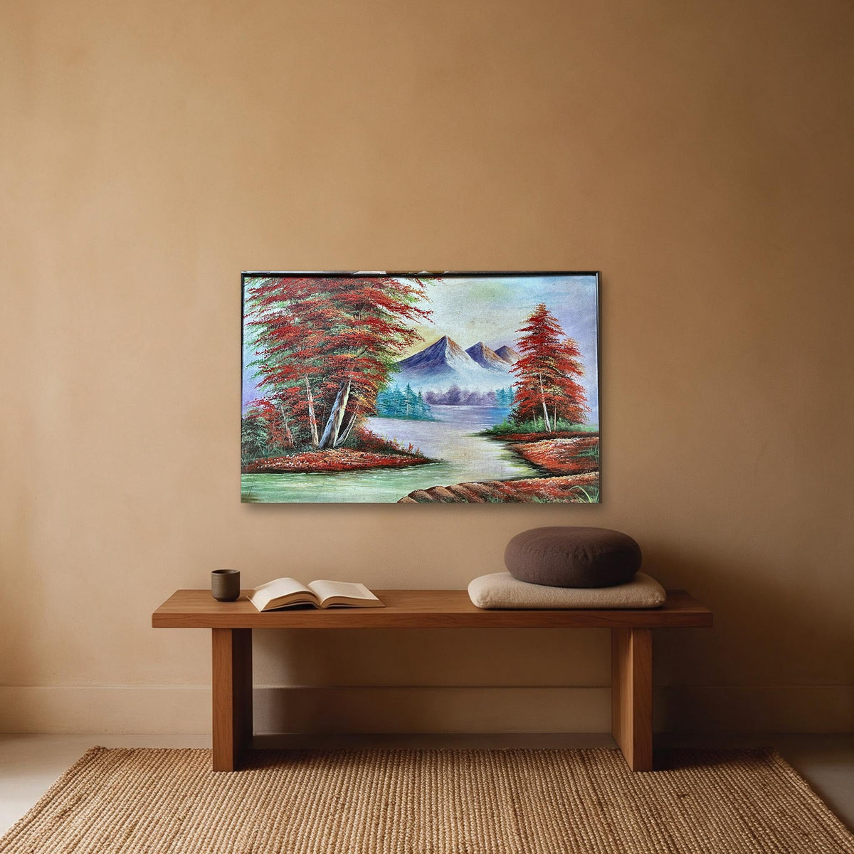 Hand-painted mountain river landscape canvas with red autumn trees and snow peaks, shown in a meditation corner