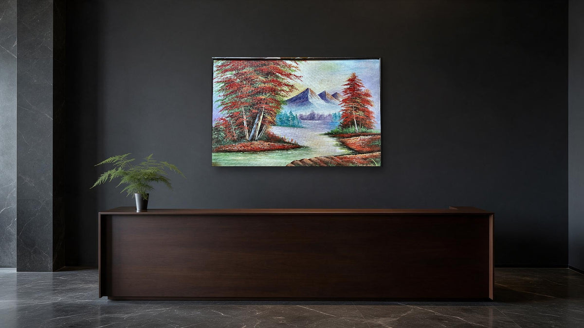 Hand-painted mountain river landscape canvas with red autumn trees and snow peaks, shown in an office reception